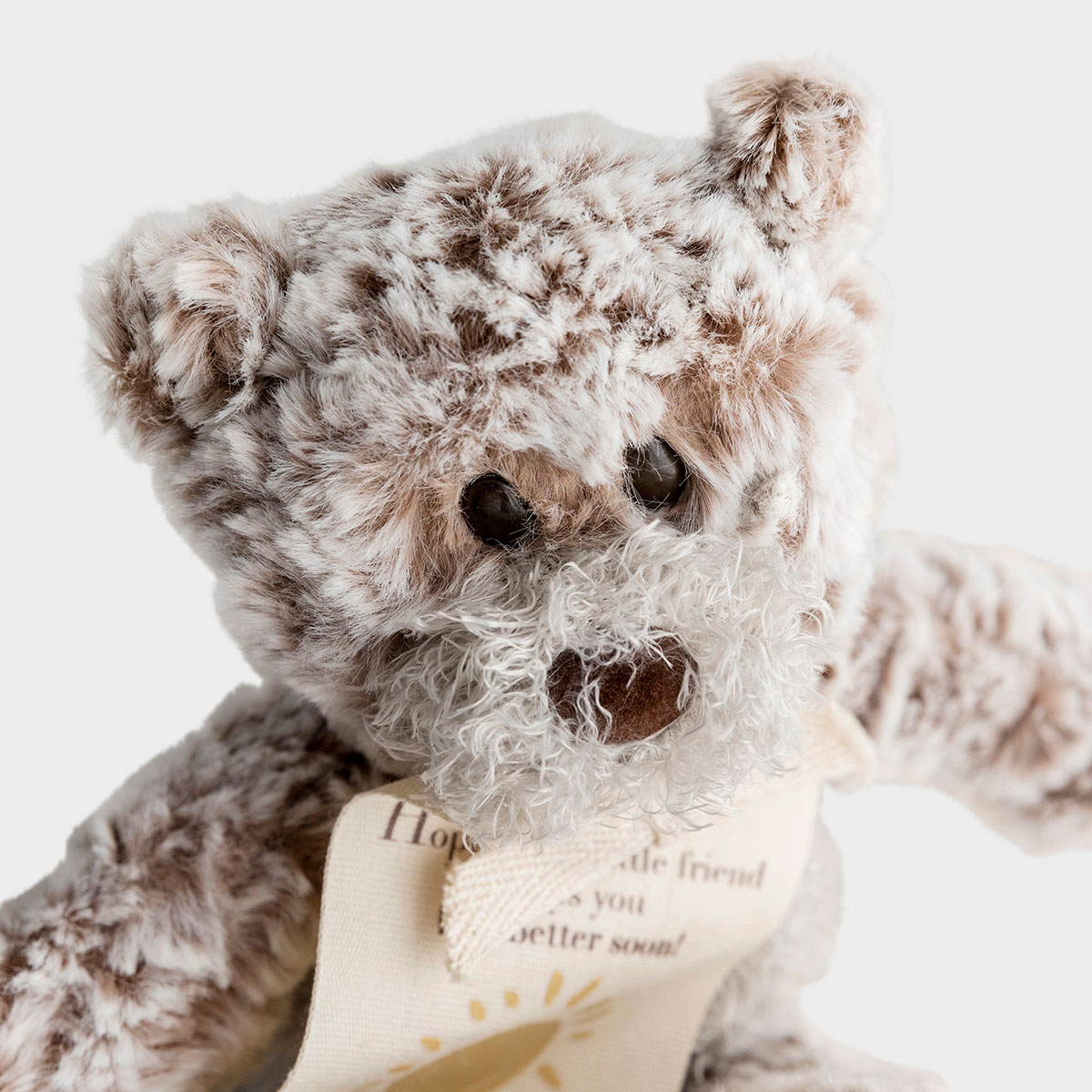 This mini plush giving bear is a perfect gift to wish a friend or family member to feel better soon. The soft fabric of this taupe, stuffed teddy bear is soothing to the touch.